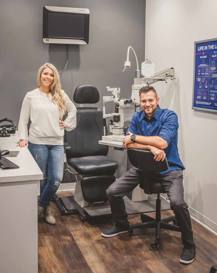 Dr. Megan and Dr. Marc in an exam room beside the slit lamp
